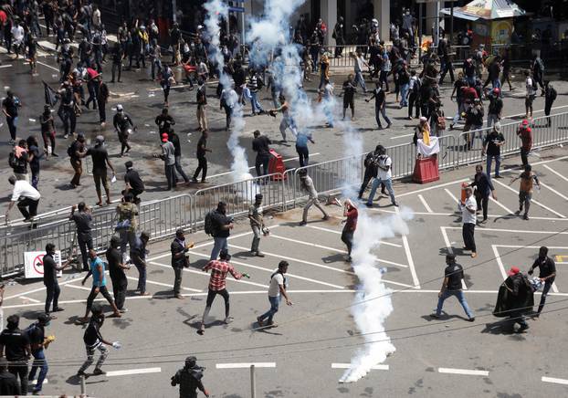 Police use tear gas to disperse demonstrators near President's residence, in Colombo