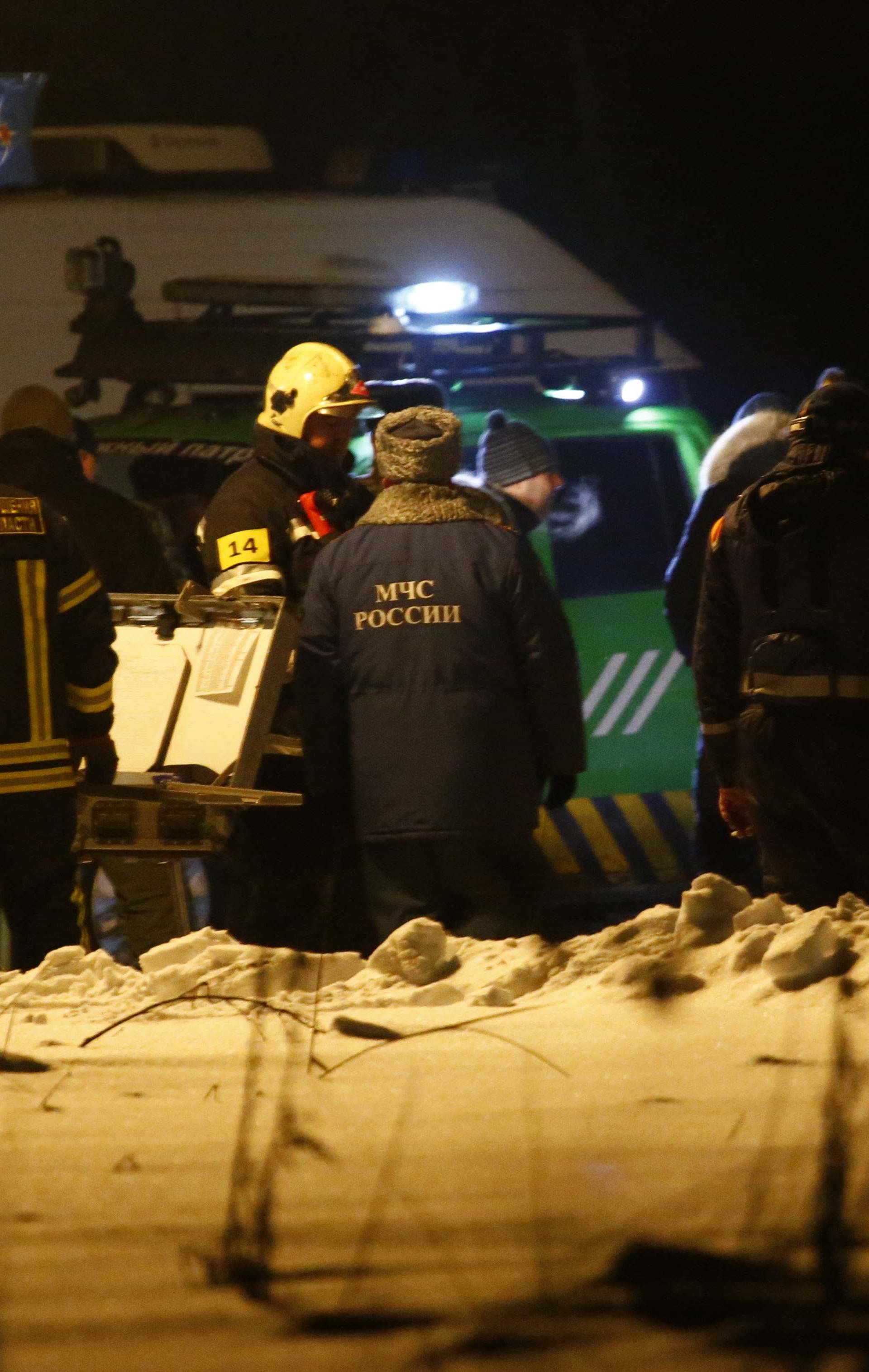 Emergency services work at the scene where a Saratov Airlines Antonov AN-148 plane crashed after taking off from Moscow's Domodedovo airport, outside Moscow