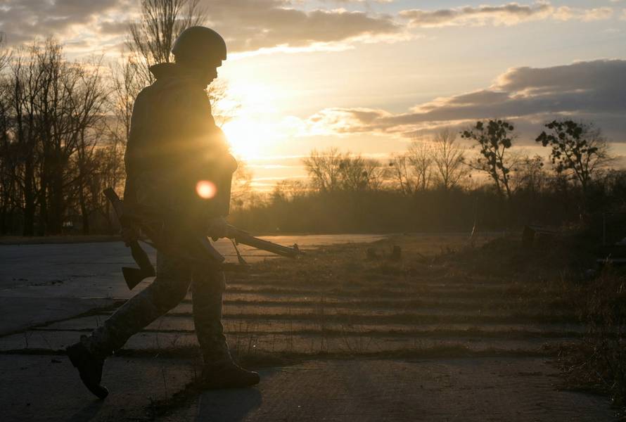 A Ukrainian serviceman takes position at the military airbase Vasylkiv in the Kyiv region