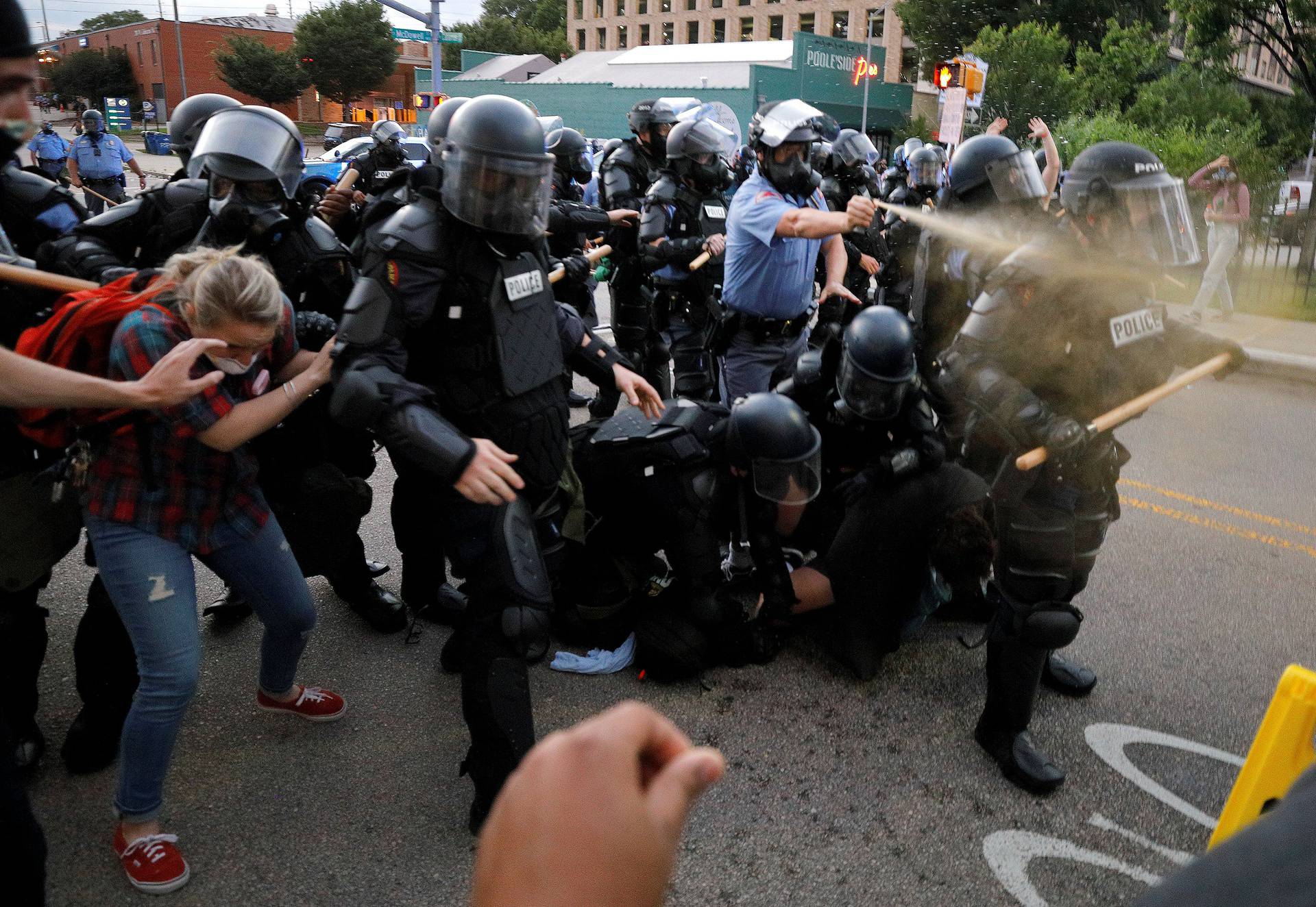 A policeman discharges pepper spray during nationwide unrest following the death in Minneapolis police custody of George Floyd, in Raleigh