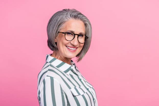 Profile photo of satisfied charming grey hair senior hr manager woman smiling enjoy recruiting more specialists isolated on pink color background