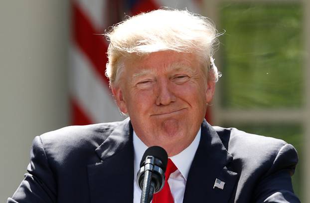 U.S. President Trump pauses as he announces his decision to withdraw from Paris Climate Agreement at White House in Washington