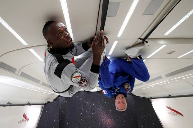 Retired sprinter Usain Bolt and French astronaut Jean-Francois Clervoy enjoy zero gravity conditions during a flight in a specially modified plane above Reims