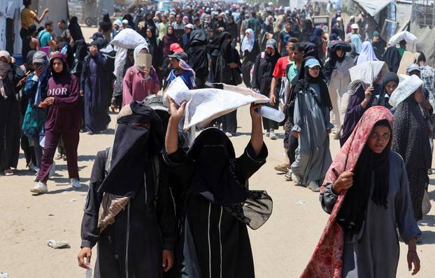 Palestinians seek aid from the U.S.-backed Gaza Humanitarian Foundation, near Rafah