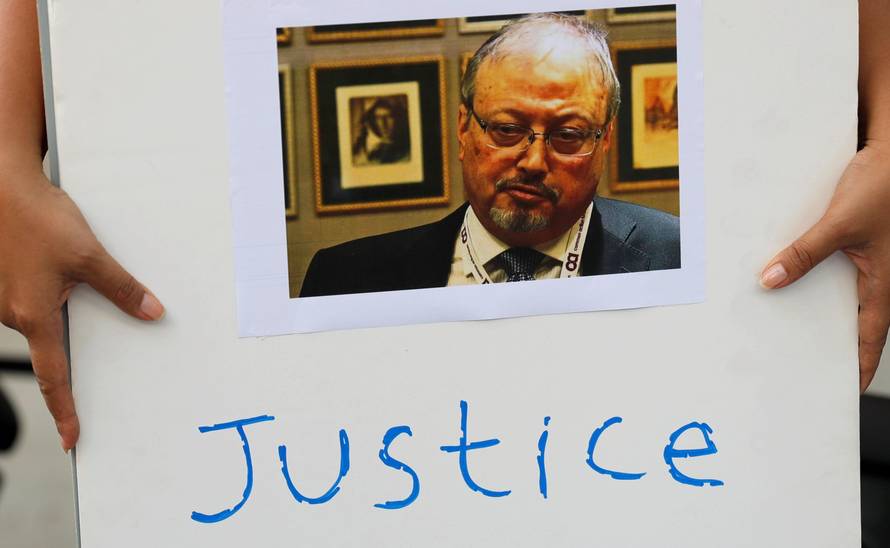 An Indonesian journalist holds a placard during a protest over the disappearance of Saudi journalist Jamal Khashoggi in front of the Saudi Arabia embassy in Jakarta