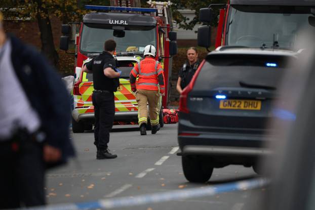 Police officers work at the scene following an incident outside a synagogue, in Manchester