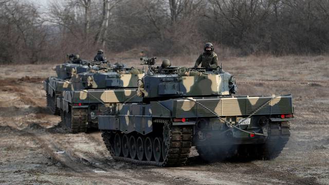 FILE PHOTO: Leopard 2A4 tanks take part in a military training near Tata