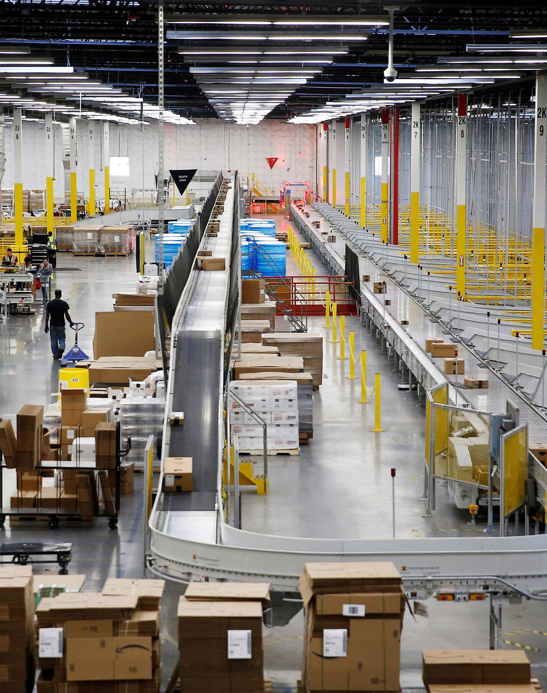 FILE PHOTO: The ship sorter automatically feeds packages for delivery by speed and location to chutes connected to delivery trucks at the Amazon fulfillment center in Kent