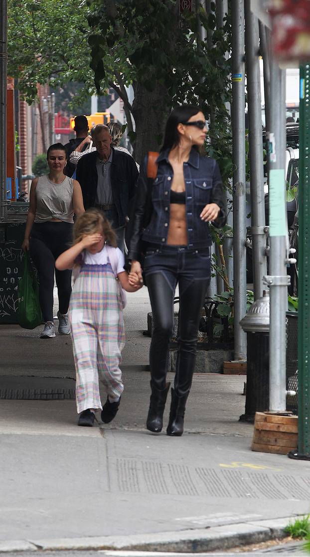 Irina Shayk flashes her bra and taut tummy in double-denim outfit to pick up daughter Lea from school in NYC