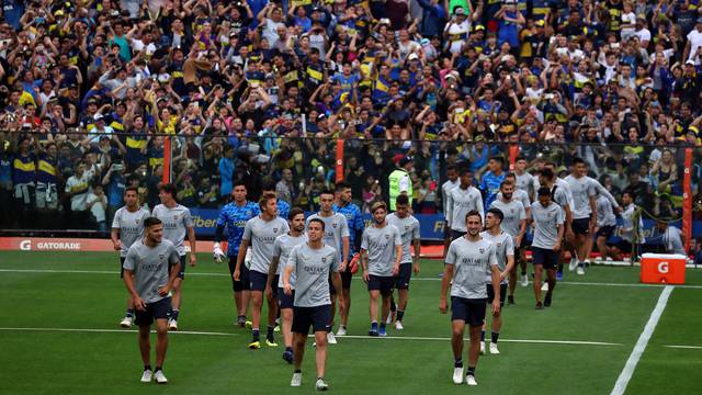 Boca Juniors' players enter the field during a training session open to the public ahead of their second leg Copa Libertadores final match against River Plate in Buenos Aires