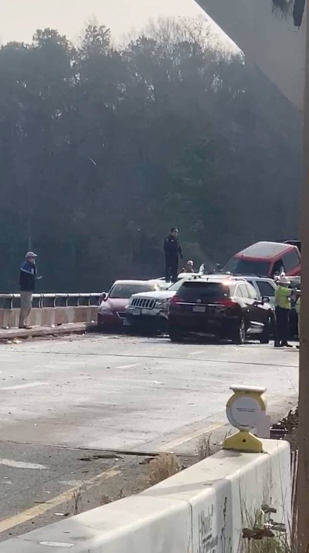 Damaged vehicles are seen after a chain reaction crash on I-64 in York County, Virginia