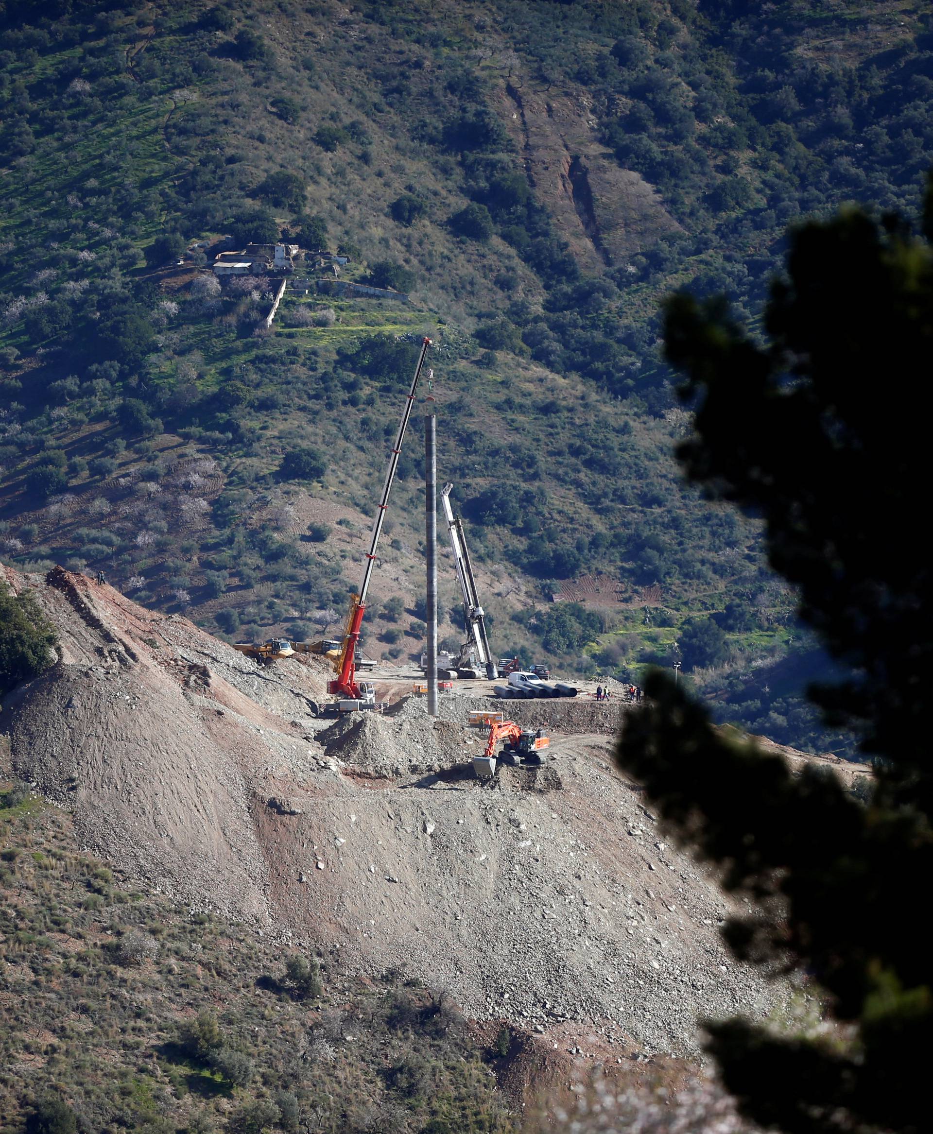 A crane removes steel tubes after failing to place them into the drilled well at the area where Julen, a Spanish two-year-old boy, fell into a deep well nine days ago when the family was taking a stroll through a private estate, in Totalan