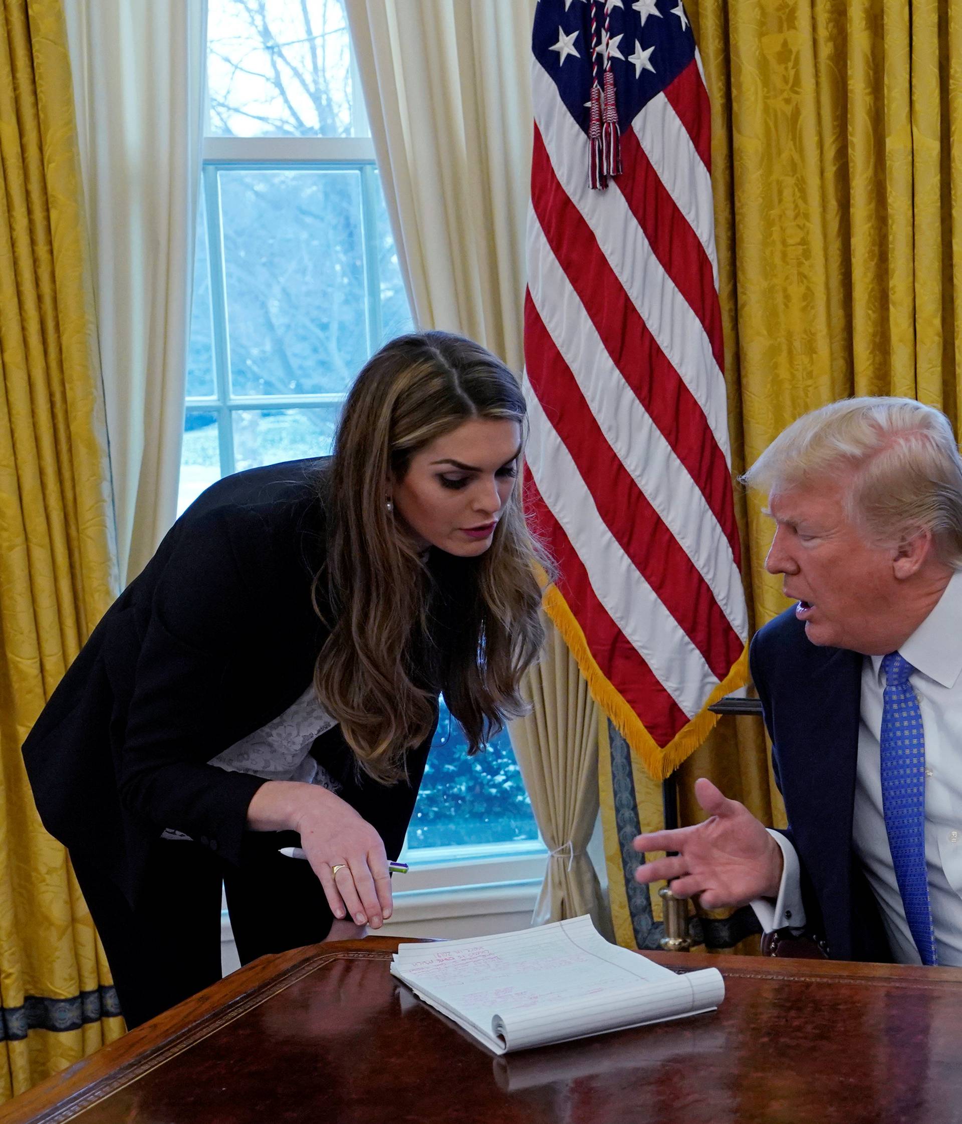 U.S. President Donald Trump speaks with Hope Hicks during an interview with Reuters in Washington