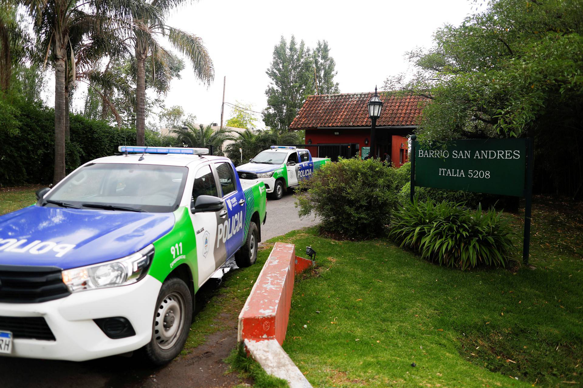 Police cars are seen outside the house where Diego Maradona was recovering from surgery, in Tigre