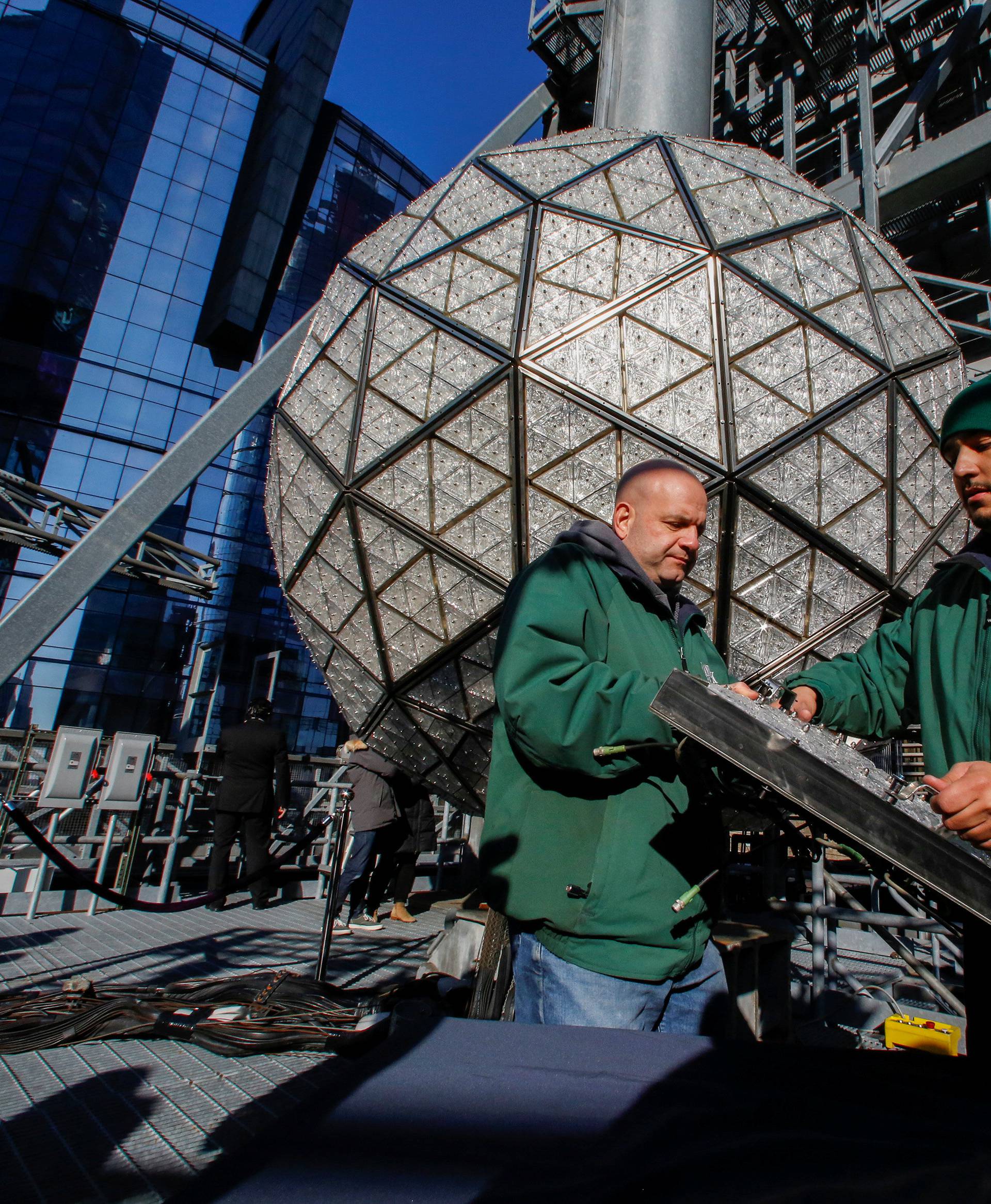 Workers prepare a panel of Waterford Crystal triangles before attaching it to the Times Square New Year's Eve Ball on the roof of One Times Square in Manhattan, New York