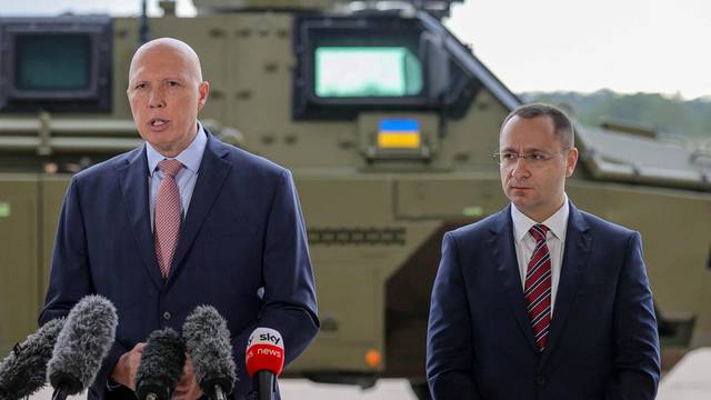 Defence Minister Peter Dutton makes an announcement regarding defensive military assistance to Ukraine as a Bushmaster PMV is loaded into a C-17 Globemaster in Brisbane