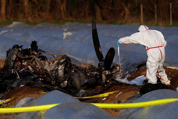 A Forensic expert works next to the remains of a small plane that crashed near Erzhausen