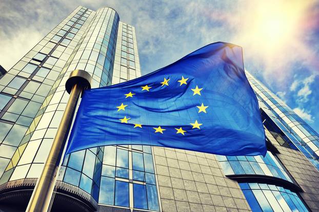 Eu,Flag,Waving,In,Front,Of,European,Parliament,Building.,Brussels,