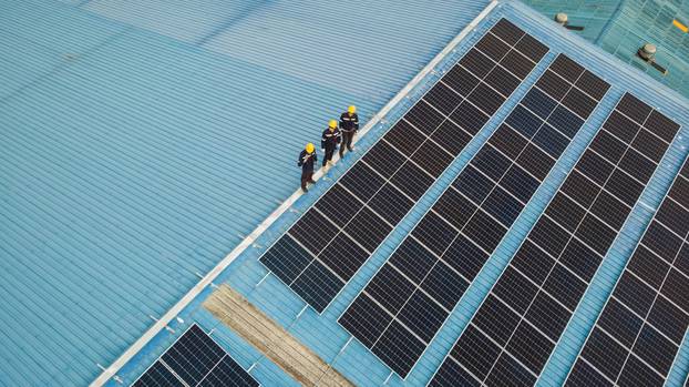 Aerial,View,Of,Engineer,Worker,Walking,On,Rooftop,Checking,On