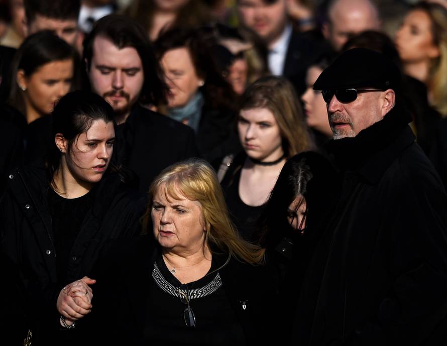 Eillen O'Riordan leaves her daughter Dolores O'Riordan's funeral with Dolores' ex-husband Don Burton and one of their daughters at St Ailbe's Church in Ballybricken