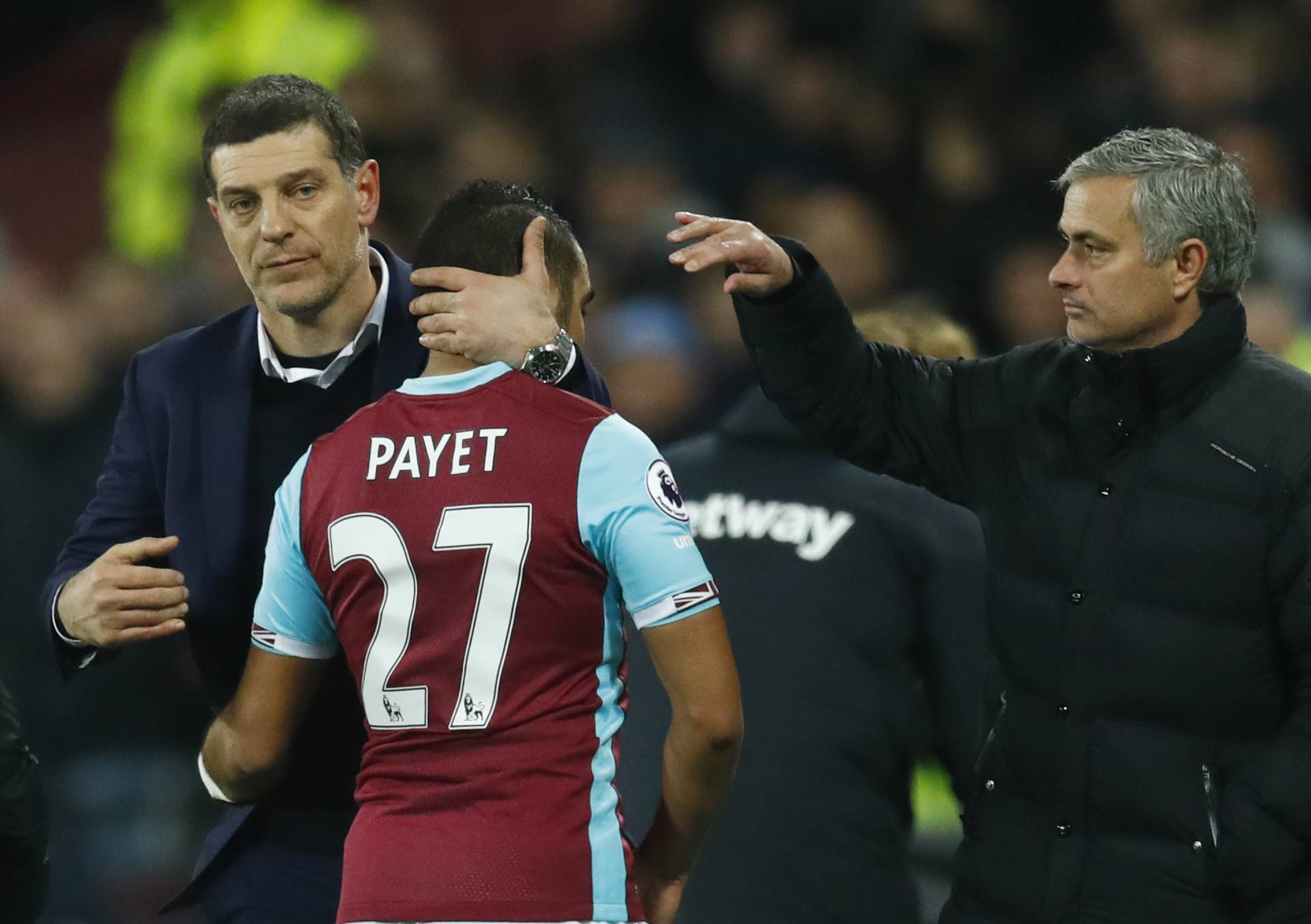 Manchester United manager Jose Mourinho gestures as West Ham United's Dimitri Payet hugs West Ham United manager Slaven Bilic after he is substituted off