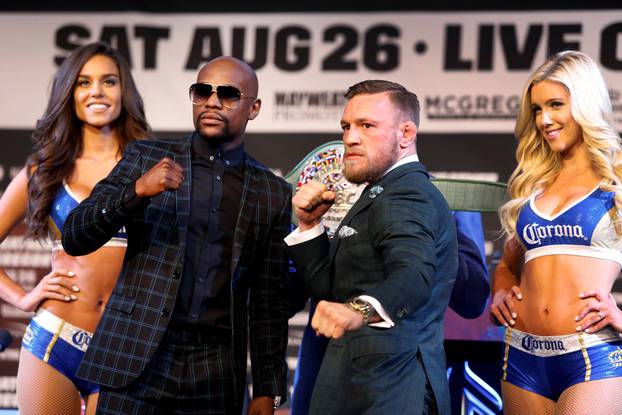 Floyd Mayweather Jr. (L) of the U.S. and Conor McGregor of Ireland pose during a news conference in Las Vegas