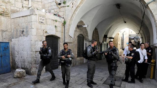 Israeli border policemen secure the area near the scene of the shooting attack, in Jerusalem's Old City