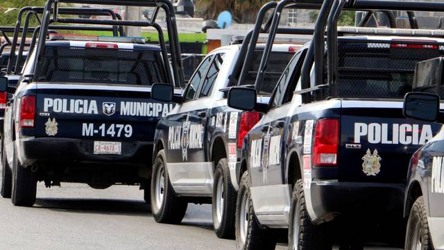 Police officers stand guard along a street in Saltillo