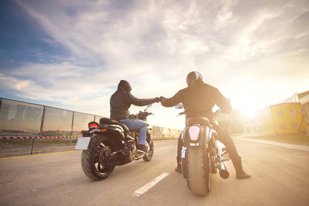 Two,Bikers,Ot,Motocycles,Handshaking,With,Knuckle,On,Road,At