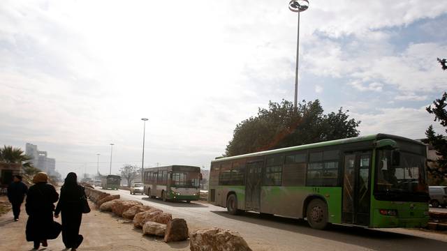 Empty buses are seen leaving after the evacuation of people from eastern Aleppo was suspended