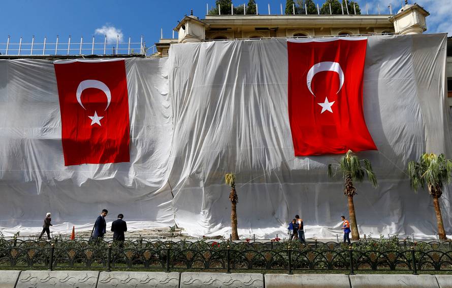 Buildings are seen covered and decorated with Turkish flags after Tuesday's car bomb attack on a police bus, in Istanbul