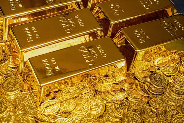Gold,Bars,Are,Placed,On,A,Pile,Of,Gold,Coins