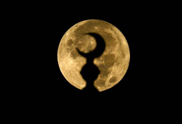 The Blue Moon, this year's biggest and brightest super moon, appears in Gaza's skies, in Khan Younis