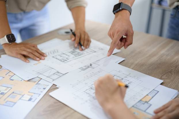 Engineering,Construction,Concept,,Engineers,Team,Point,Blueprint,Of,Building,To