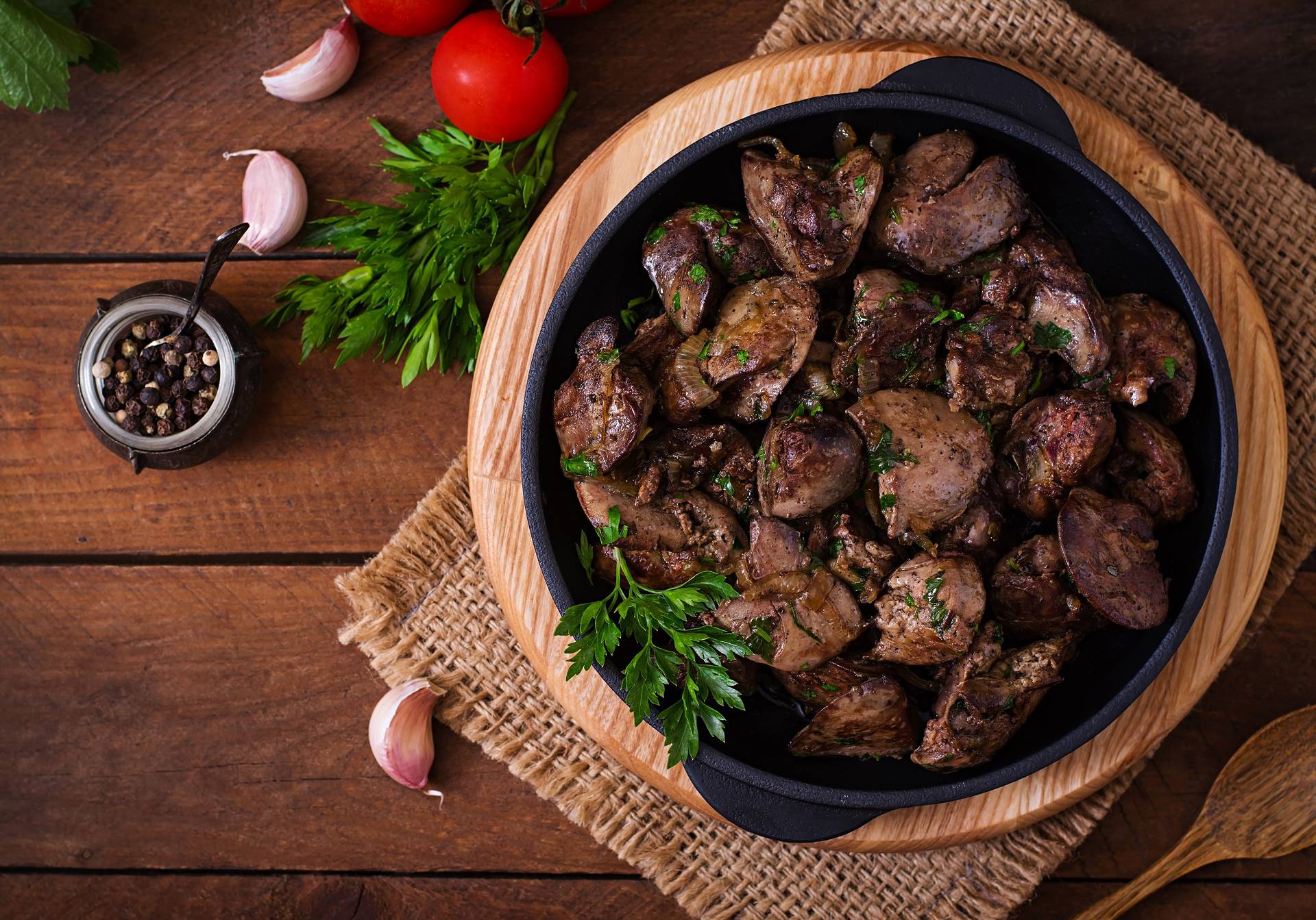 Fried chicken liver with onions and herbs. Top view