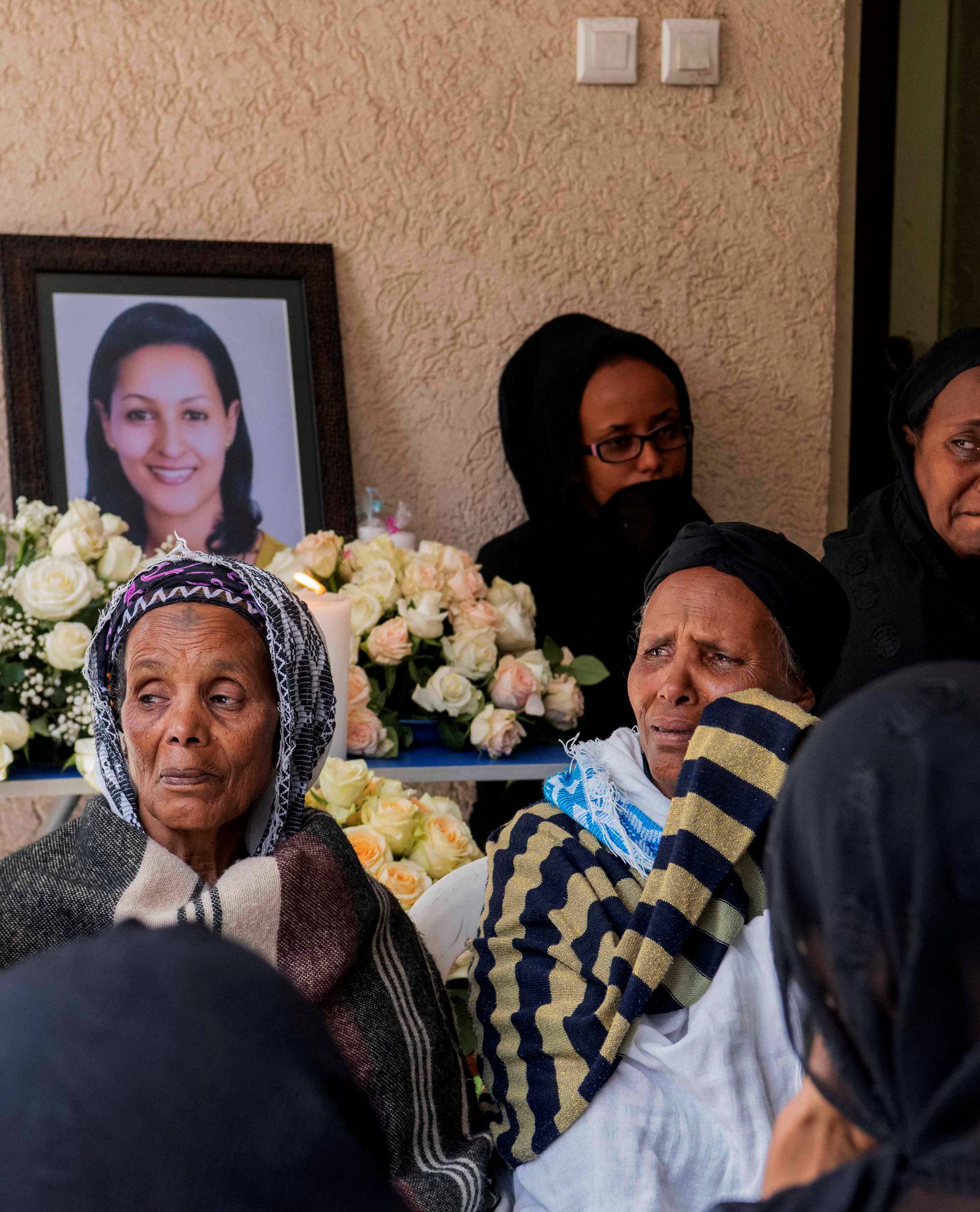 Relatives and friends of Sara Gebremichael, a senior hostess and a crew leader on the Ethiopian Airlines Flight ET 302 plane that crashed, mourn at her house in Addis Ababa