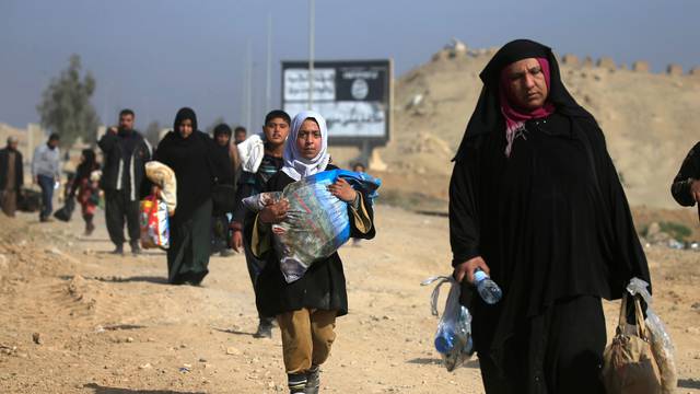 Displaced Iraqi people flee their homes, during the battle against Islamic State militants, at the district of al-Mamoun in Mosul