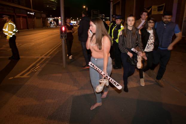 Concert goers react after fleeing the Manchester Arena in northern England where U.S. singer Ariana Grande had been performing in Manchester