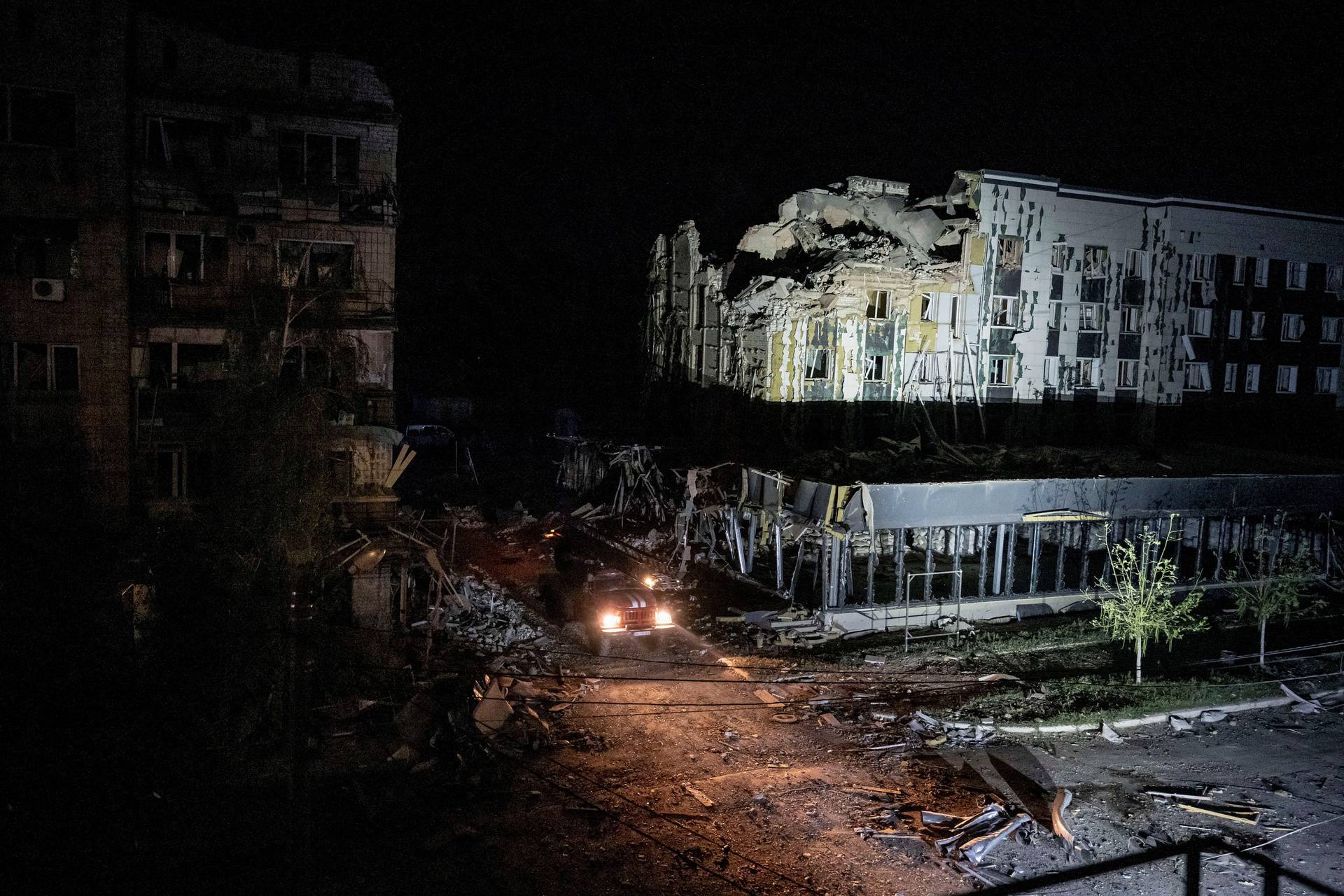 Rescuers work at a site of a building destroyed during a Russian missile strike in Pokrovsk