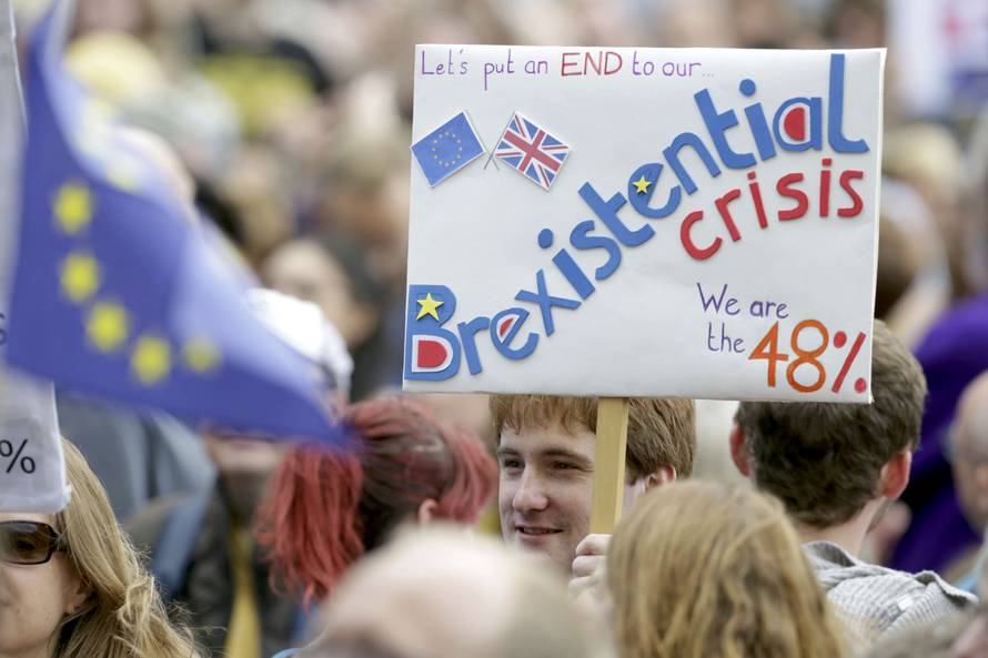A man holds a banner during a demonstration against Britain's decision to leave the European Union, in central London