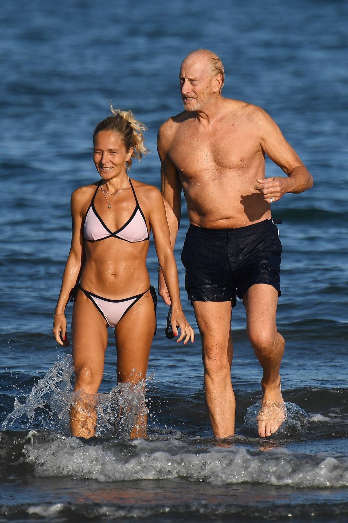 73 year old actor Charles Dance OBE looks in incredible shape as he is seen with his girlfriend at the beach in Venice!