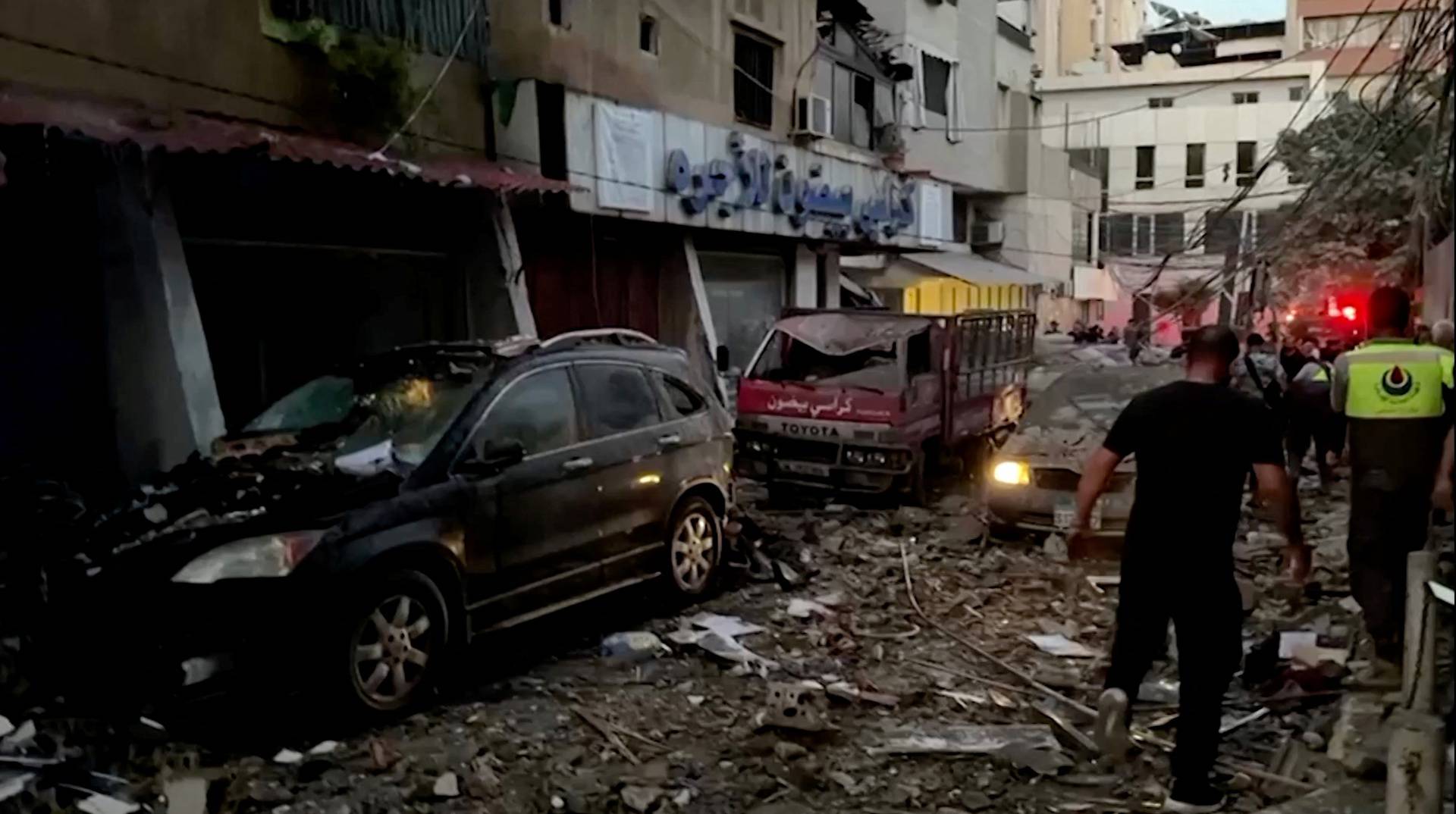 Damaged vehicles are seen after an Israeli strike on Beirut's southern suburbs