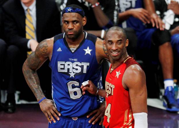 FILE PHOTO: West All Star Bryant of the Lakers stands with East All Star James of the Heat near the end of the NBA All-Star basketball game in Los Angeles