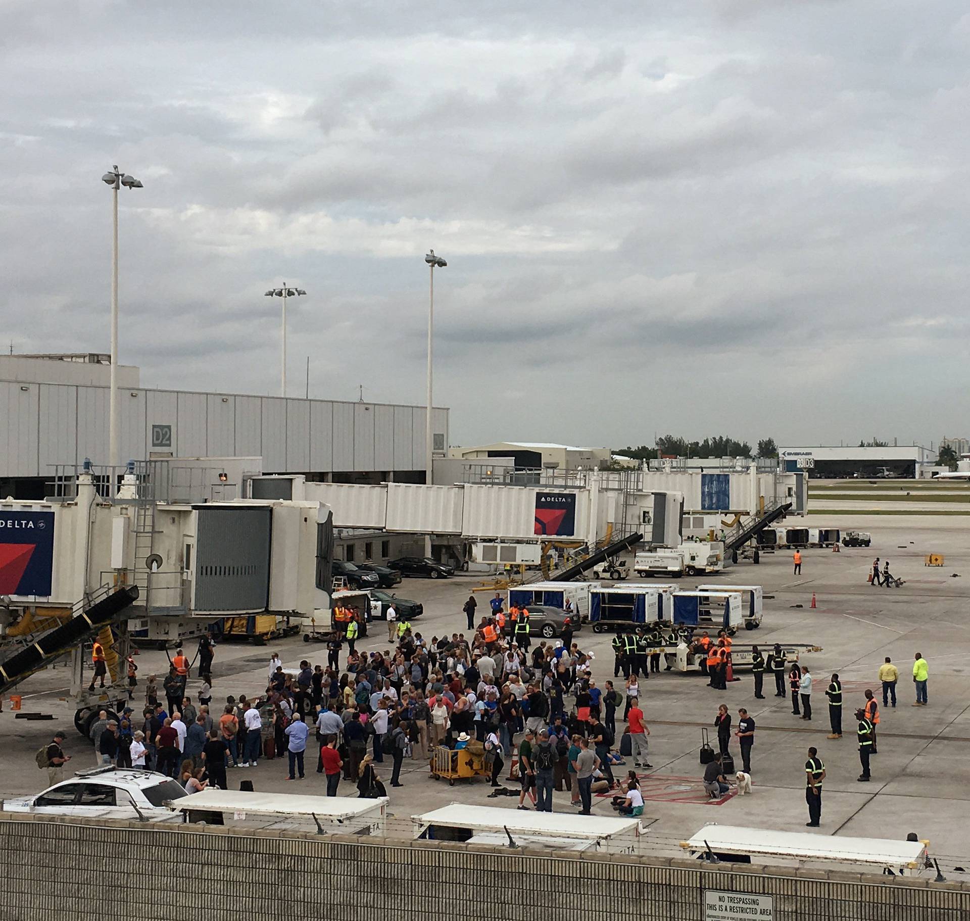 Travelers are evacuated out of the terminal and onto the tarmac after airport shooting at Fort Lauderdale-Hollywood International Airport in Florida