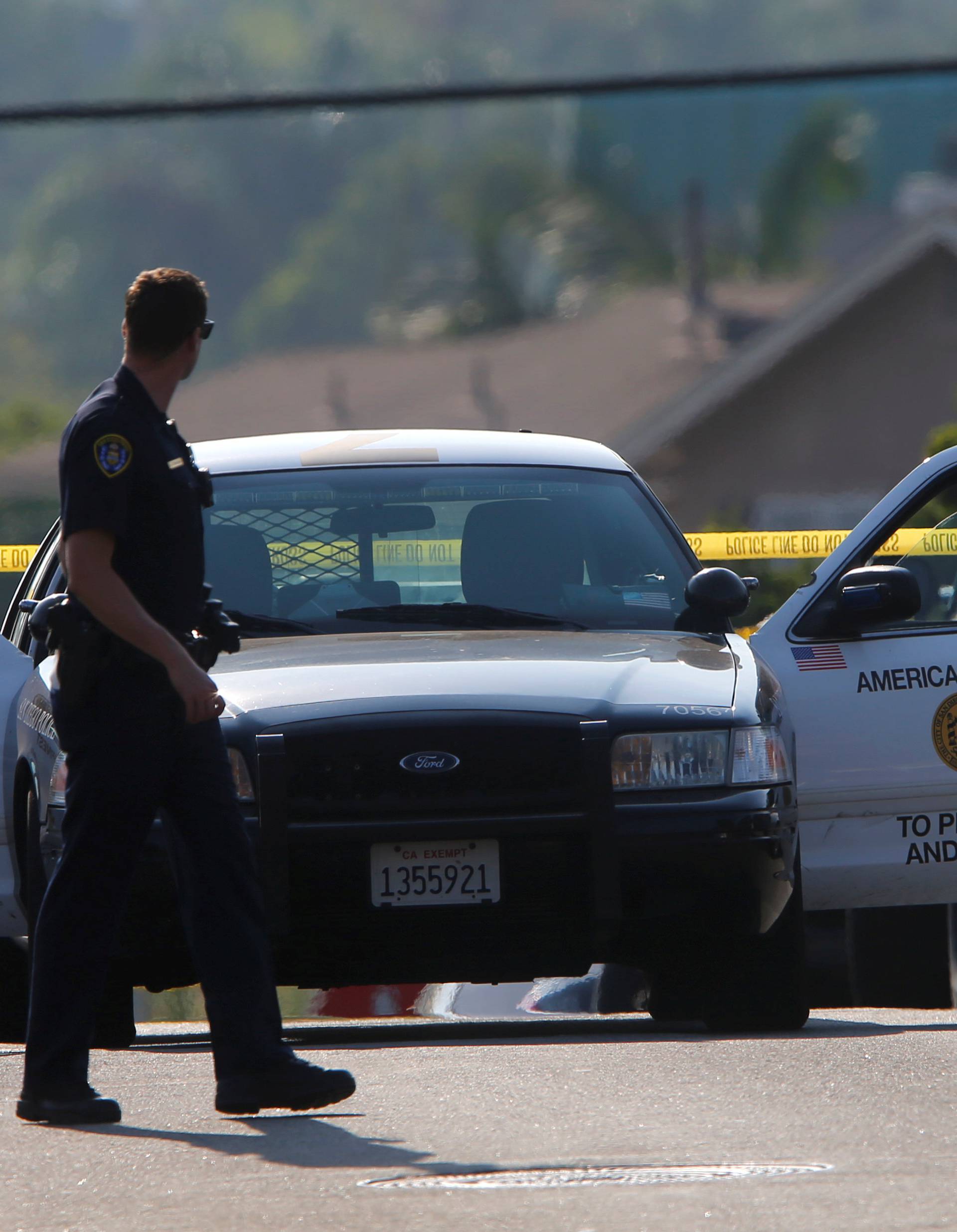 Police block off roads as they protect a crime scene and search for a second suspect after a San Diego police officer was fatally shot and another was wounded late on Thursday, in San Diego