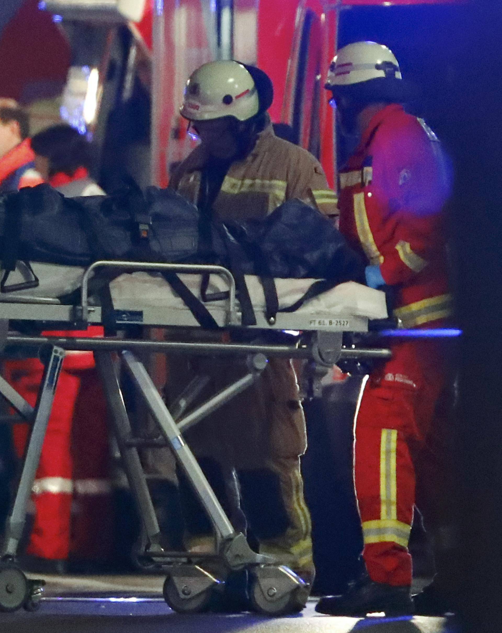 A person is carried into an ambulance near a Christmas market in Berlin