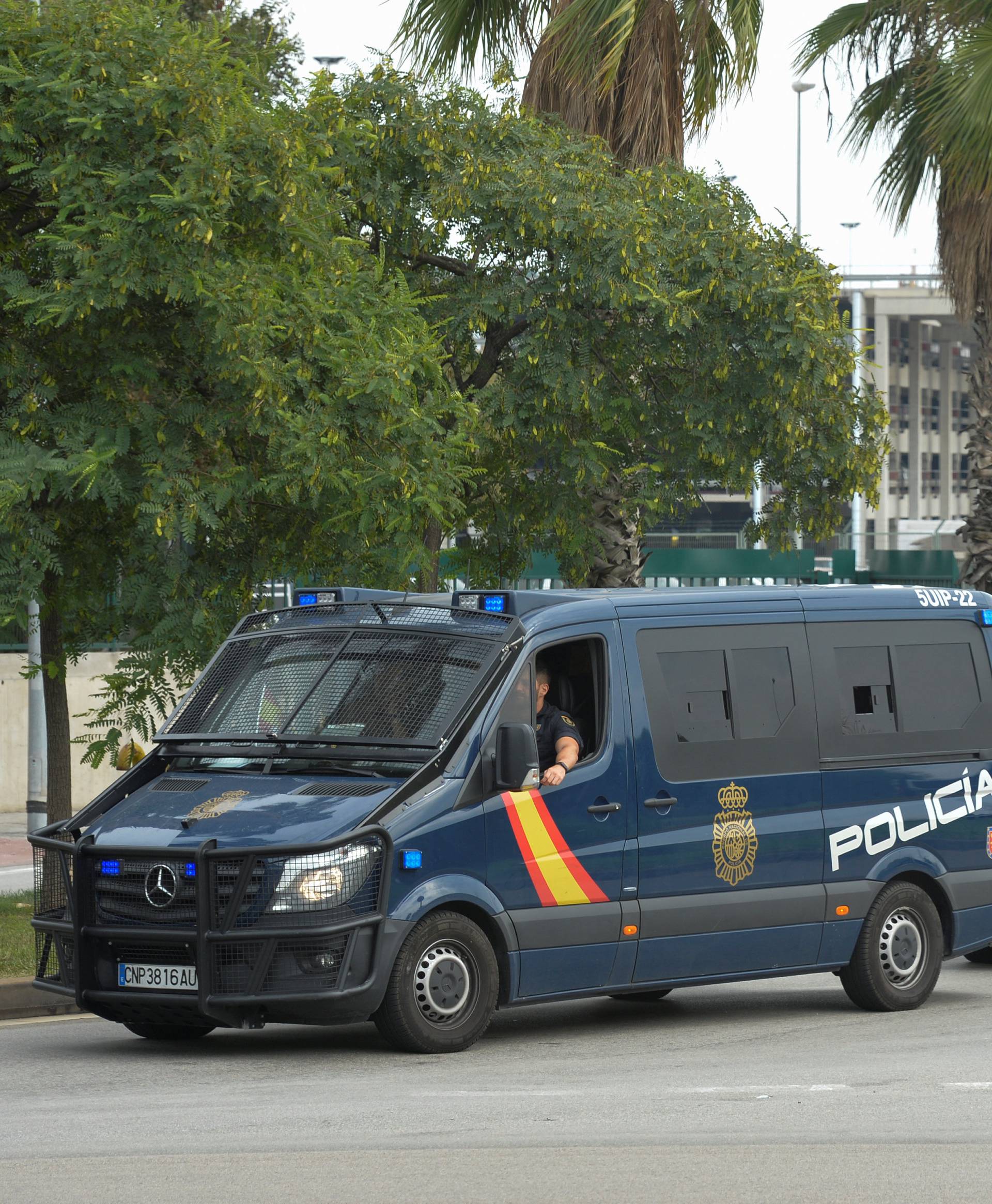 Spanish National Police vans leave the port area, where two ferries rented by Spain to house hundreds of Spanish national police and civil guard reinforcements are docked a day before the banned October 1 independence referendum, in Barcelona