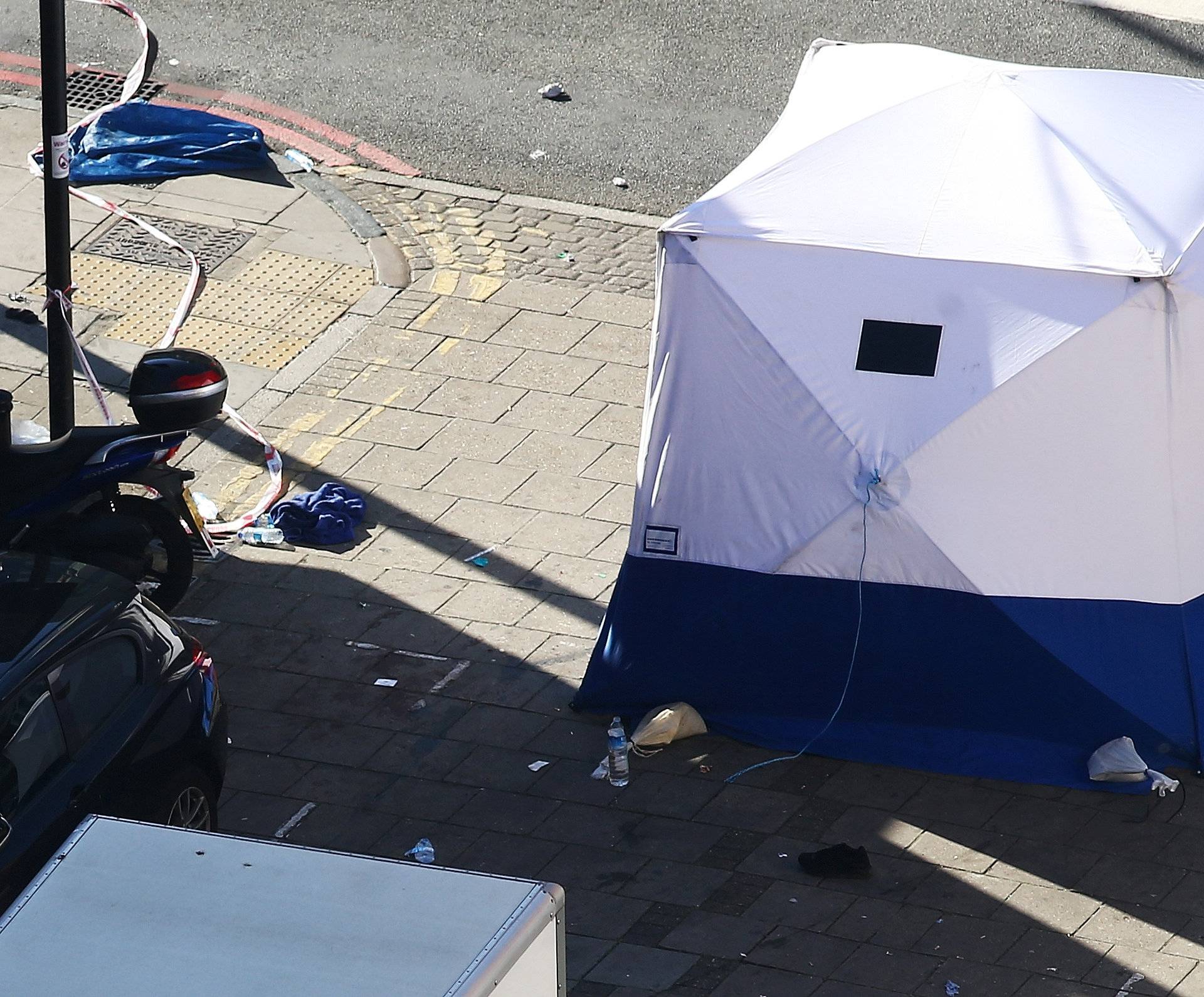 Debris and a forensic officers tent is seen at the scene after a vehicle collided with pedestrians in the Finsbury Park neighbourhood of North London