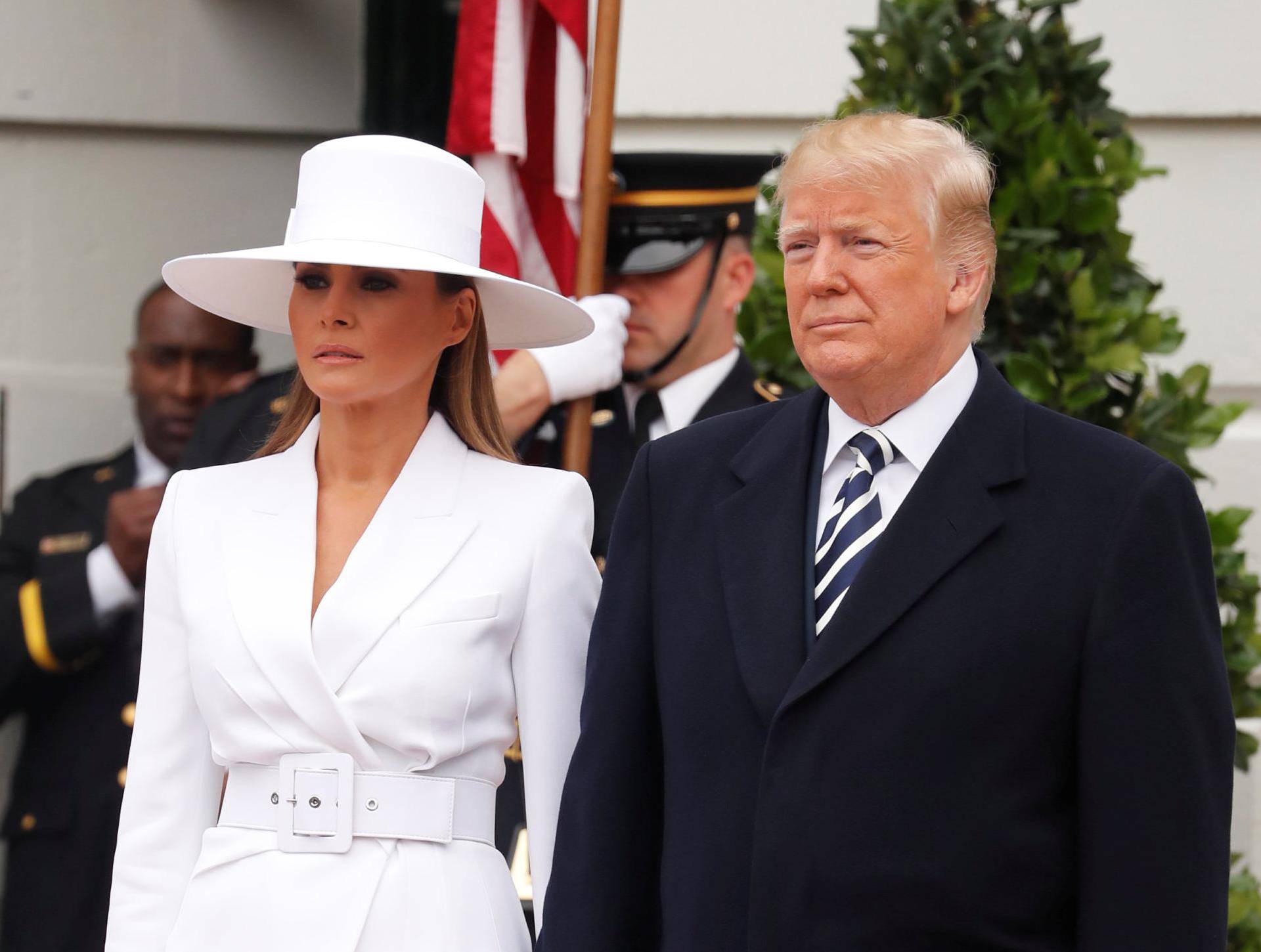 U.S. President Trump and first lady Melania wait to welcome French President Macron and his wife Brigitte during arrival ceremony at the White House in Washington