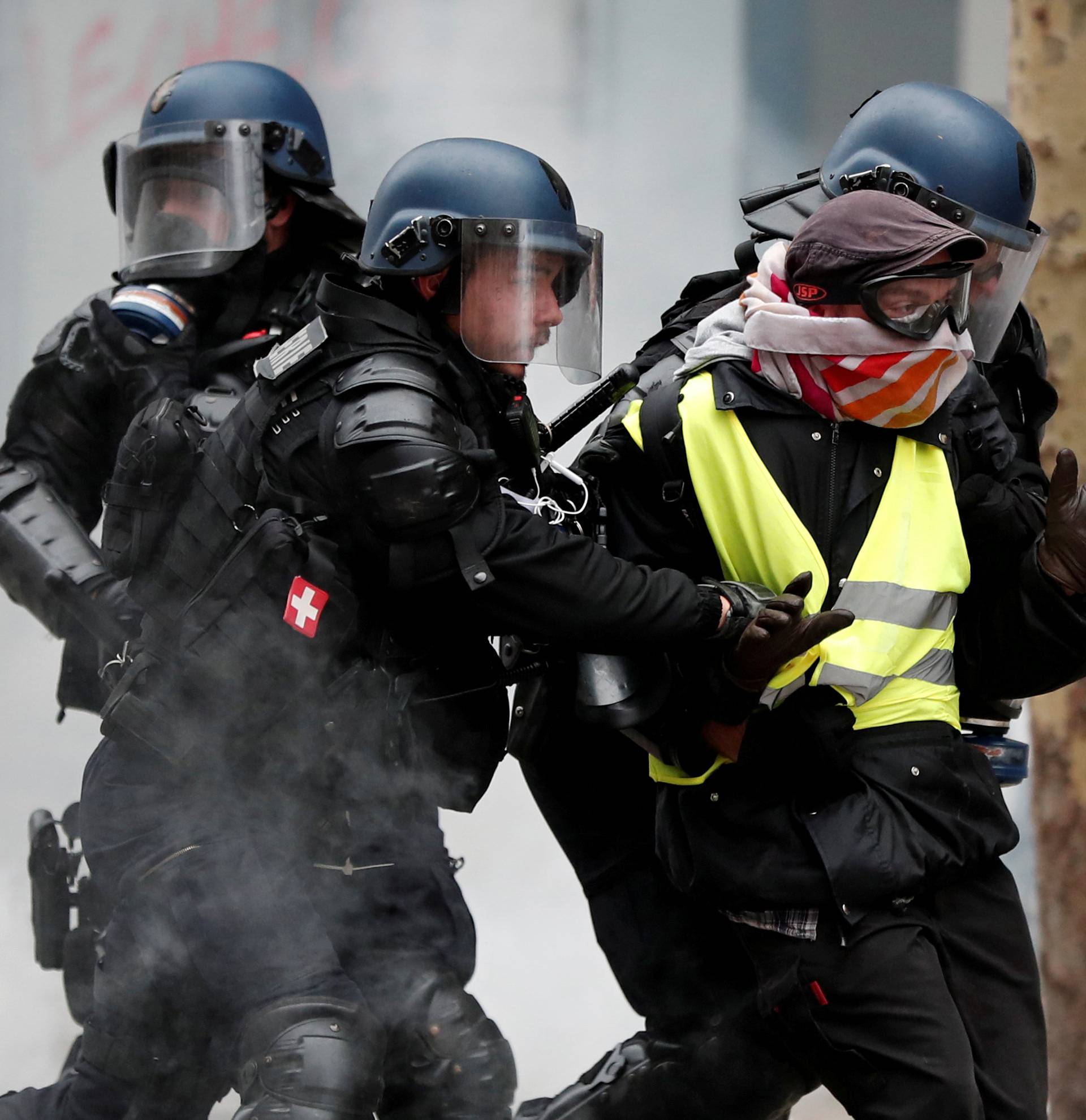 French gendarmes apprehend a protester during clashes at a demonstration by the "yellow vests" movement in Paris